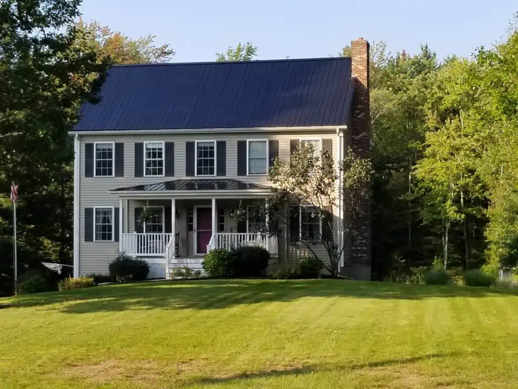 Traditonal Metal Black Metal Roof on this Colonial Style Home
